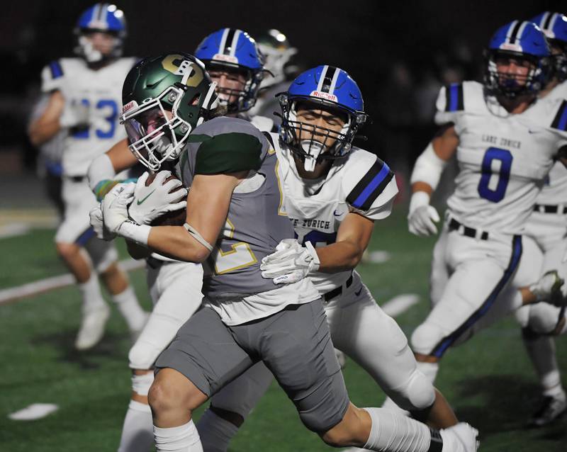 Stevenson’s Christopher Thorndyke drags Lake Zurich’s Christopher Chang into the end zone for the first touchdown of the game in Lincolnshire on Friday, September 8, 2023.