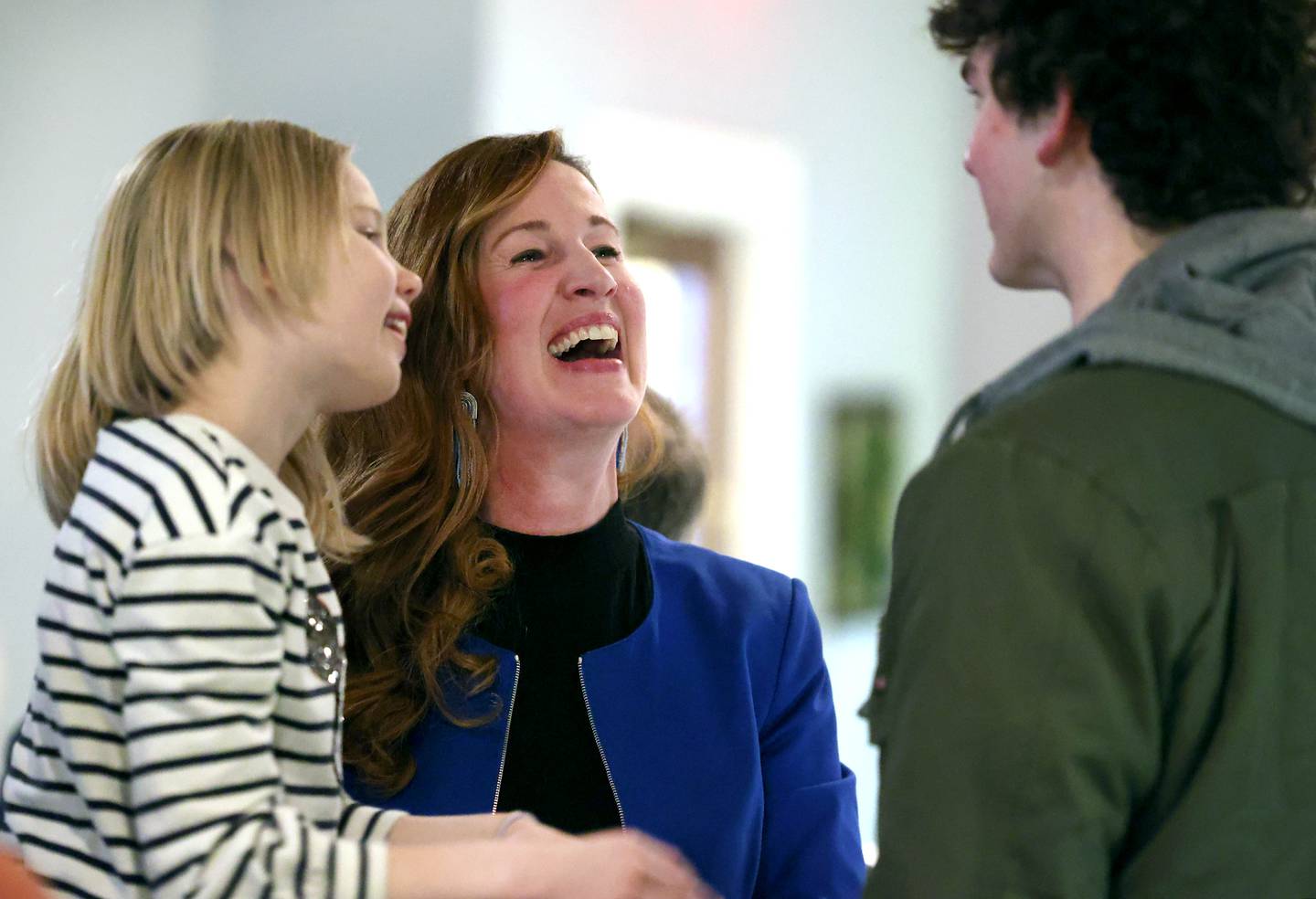 Carolyn "Morris" Zasada, DeKalb Ward 1 Alderman and candidate for the democratic nomination for the 76th district seat in the Illinois House of Representatives, talks to her daughter Alex Morris, 9, and son TJ Miller, 17, Tuesday, March 19, 2024, during her election night party at Class VI in DeKalb.