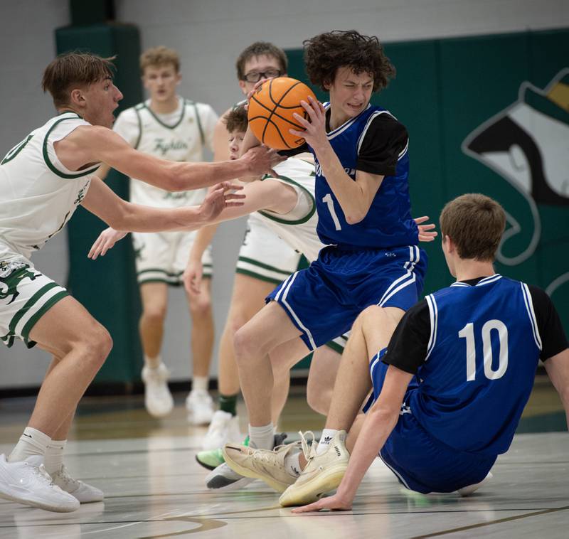 Newark's Austin Reibel, center, controls the ball as Bishop McNamara's Coen Demack, left, and Jayson Benton, background, guard in a game on Friday, Feb. 20, 2026.