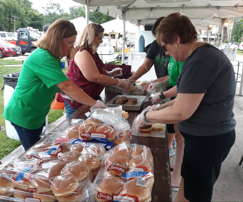 Volunteers wrap up freshly-grilled hamburgers Wednesday, Aug. 3, 2022, during the welcome burger, kicking off Shipyard Days in Seneca.