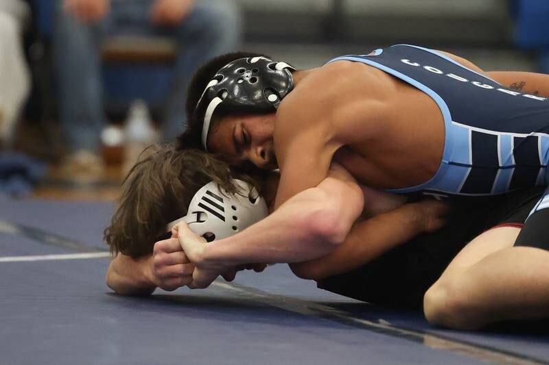 Plainfield South’s Rocco Silva works over Plainfield North’s Jaek Curran in a Southwest Prairie dual meet on Wednesday, Nov. 29, 2023 in Plainfield.