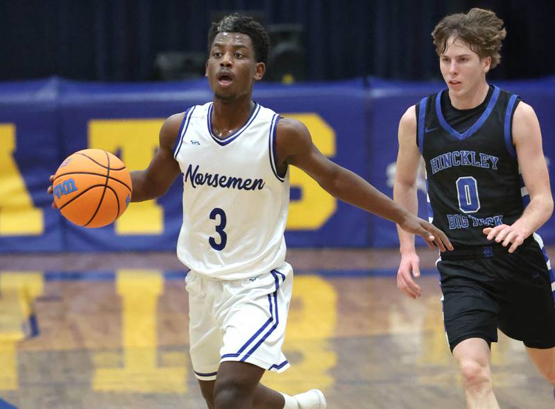 Newark's Reggie Chapman pushes the ball up court ahead of Hinckley-Big Rock's Harrison Nier Friday, Feb. 6, 2026, during their Little 10 Conference third place game at Somonauk High School.