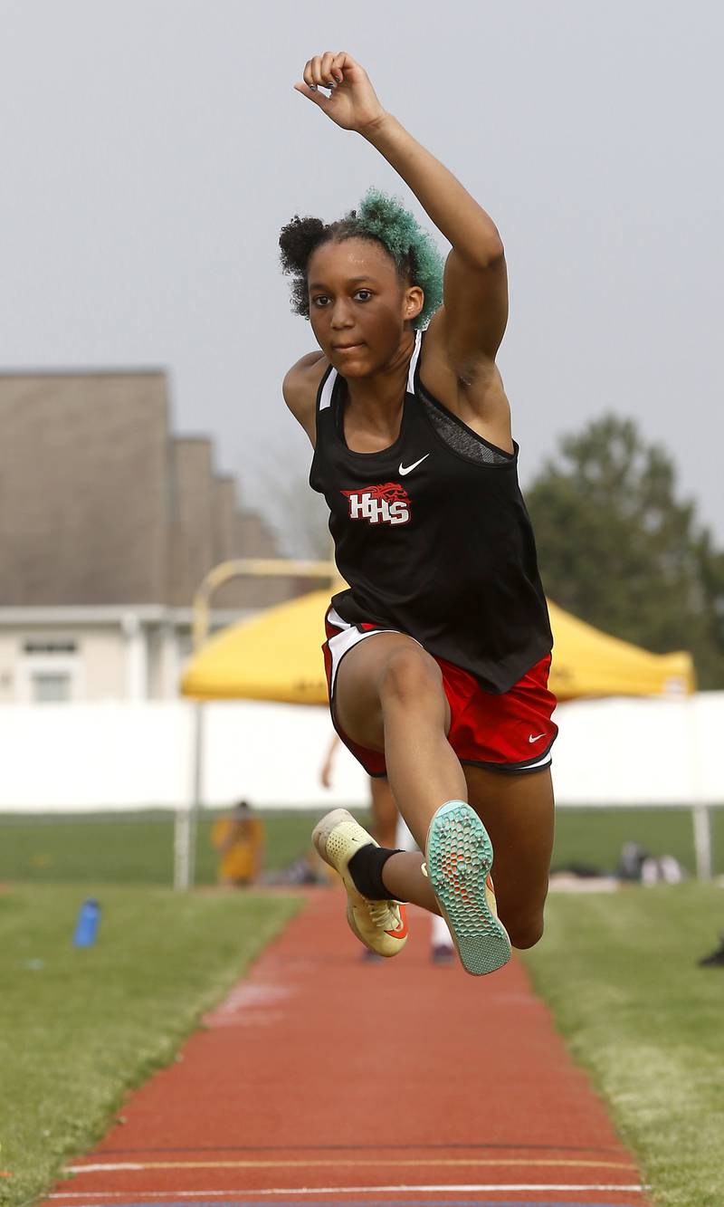 Huntley’s Dominique Johnson launches herself as she competes in the triple jump during the IHSA Class 3A Huntley Girls Track Sectional Wednesday,  May 11, 2022, at Huntley High School.