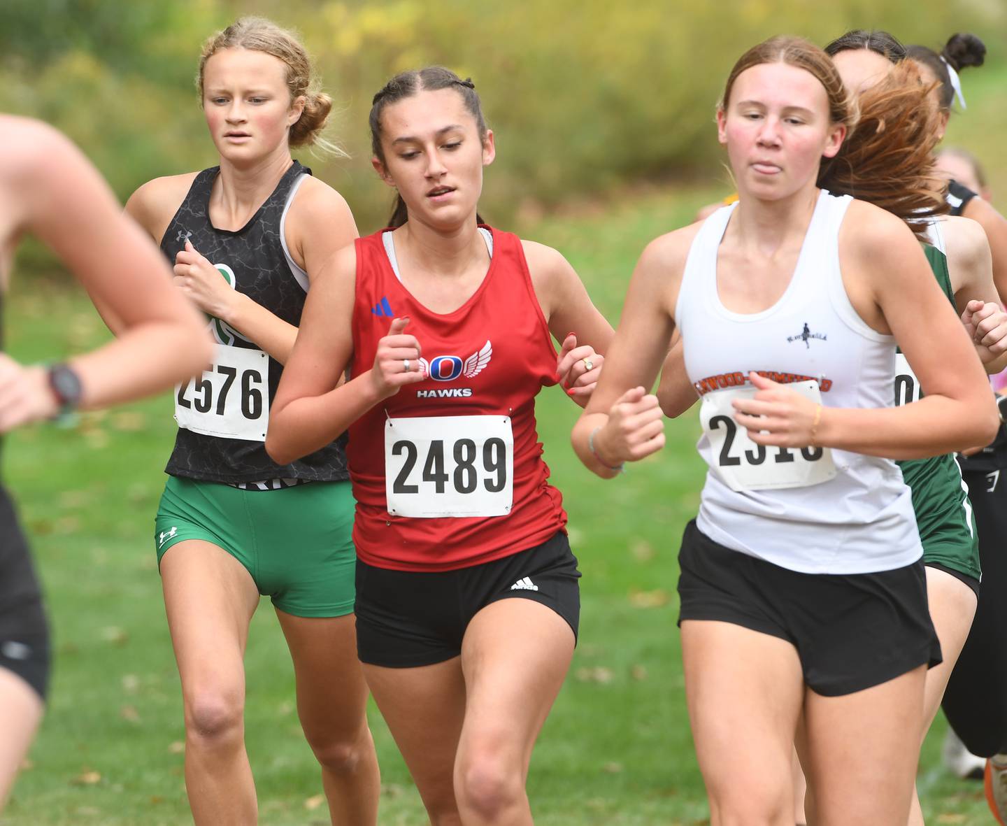 Oregon's Anya Anaya (center) runs at the Amboy Columbus Day Cross Country Invitational held at Shady Oaks Country Club near Amboy on Monday, Oct. 13, 2025.
