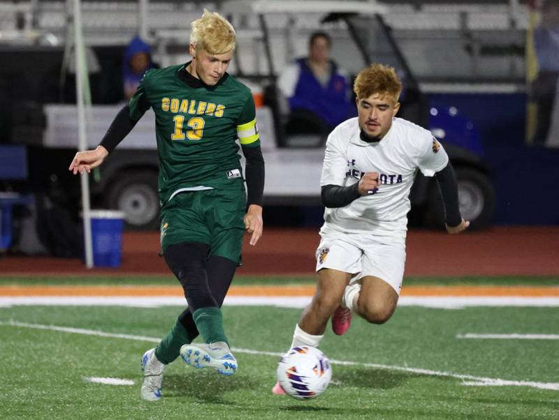 Coal City's Dane Noffsinger kicks the ball ahead of Mendota's Hugo Falcon Thursday, Nov. 6, 2025, during their Class 1A state semifinal game at Hoffman Estates High School.