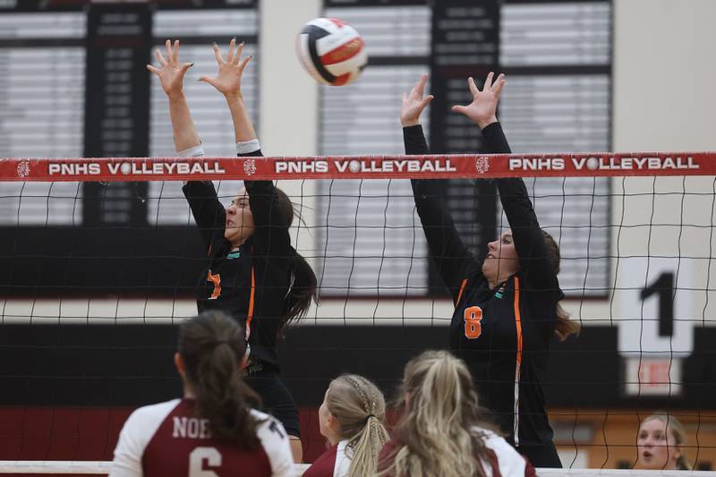 Plainfield East’s Delaney Poe (7) and Lauren Brock (8) go for the block against Plainfield North on Thursday night.