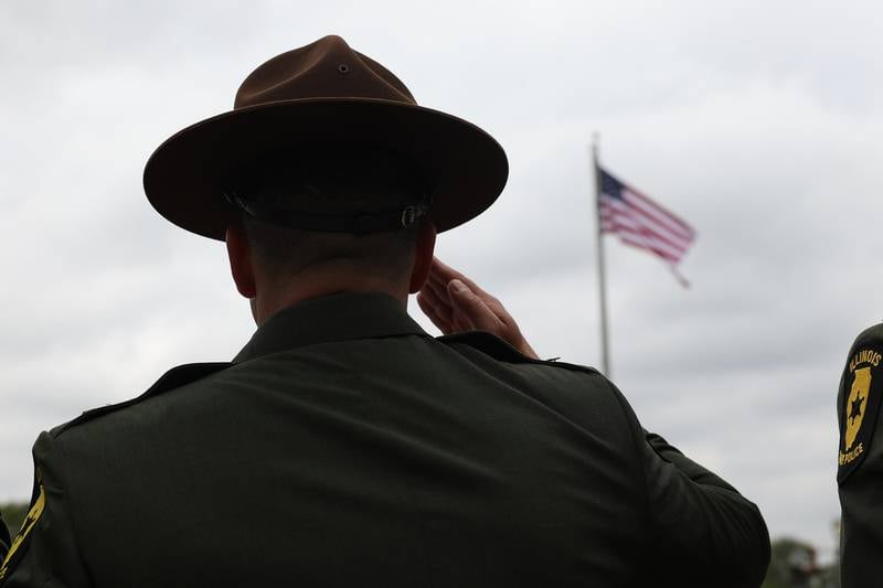 An Illinois State Police officer salutes during the playing of Taps at the Will County Law Enforcement Memorial ceremony on Thursday, May 9, 2024 in downtown Joliet.