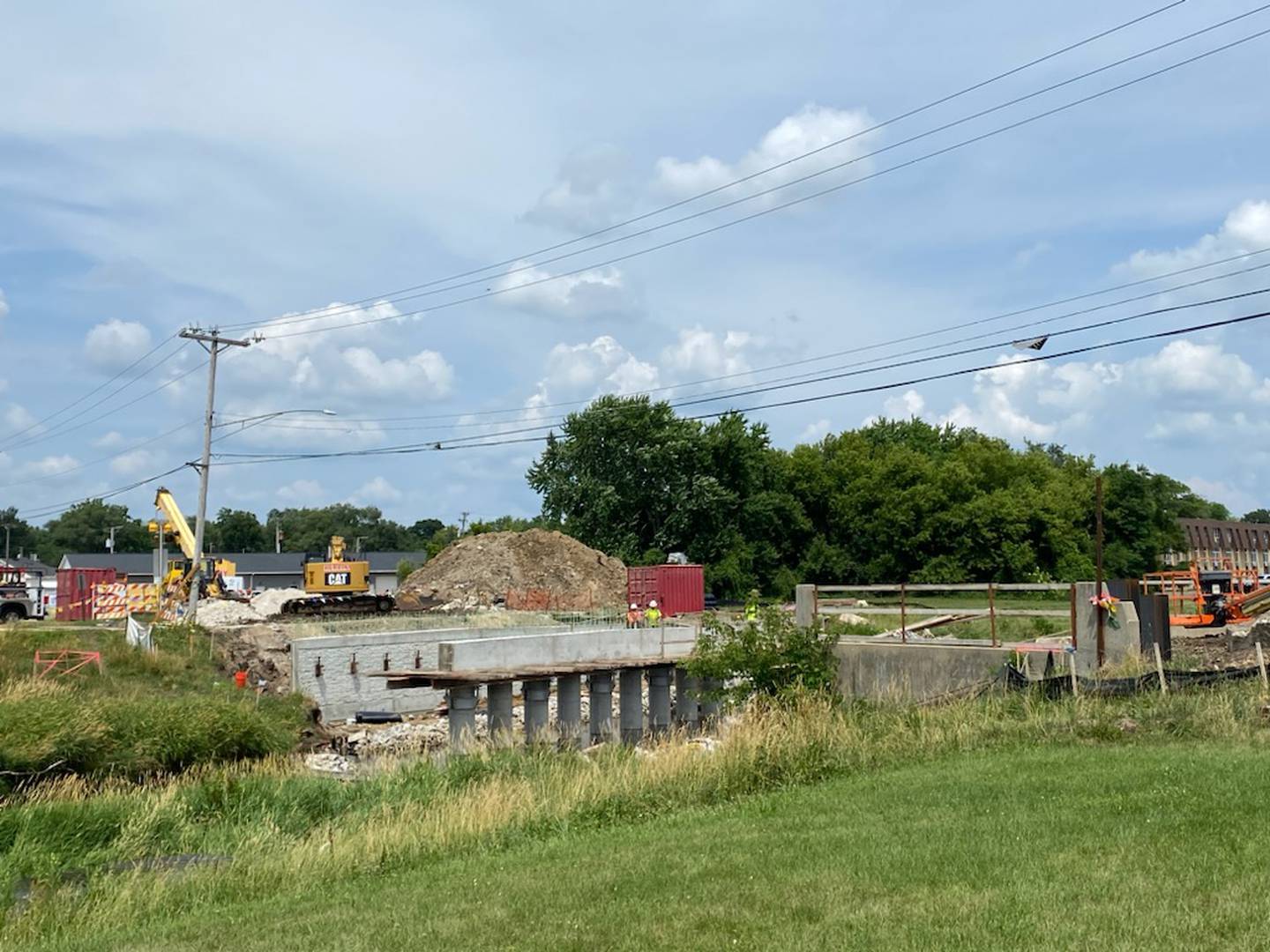 Crews and a crane seen working on the North First Street bridge replacement in DeKalb on Thursday, July 6, 2023. The road near the bridge has been closed off since March 1, when crews began the process of replacing the bridge. DeKalb city officials said delays have pushed the completion date back from August to October 2023.