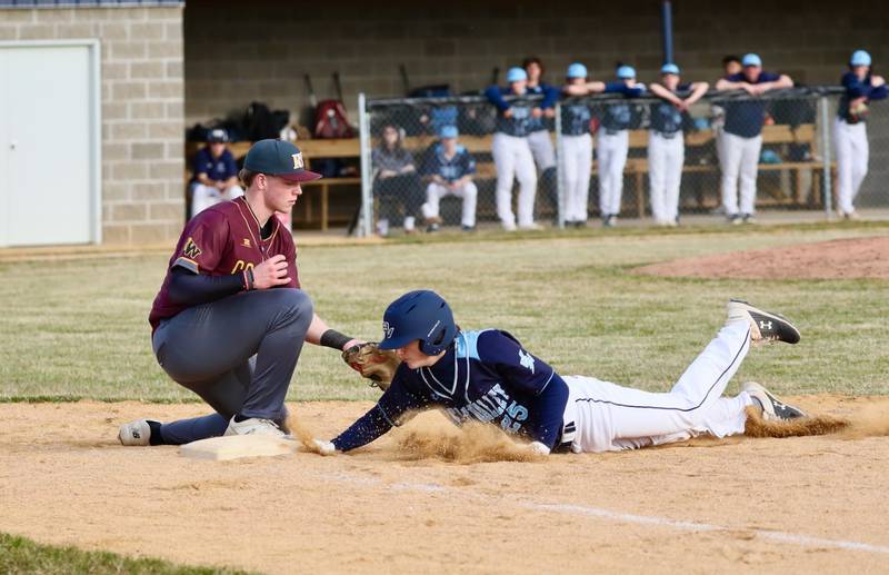 Bureau Valley senior Tyler Birkey dives back to first base against ROWVA in Tuesday's season-opener in Manlius. The visiting Cougars won 5-1.