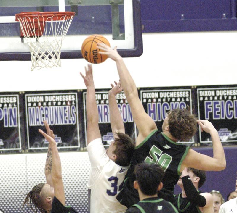 Dixon's Jacob Nicklaus and RF's Cole Mulnix go at it under the basket Dixon hosted Rock Falls in boys basketball Friday, February 14, 2025 at Lancaster Gym at Dixon High School. Rock Falls won a hard fought game 48-46.