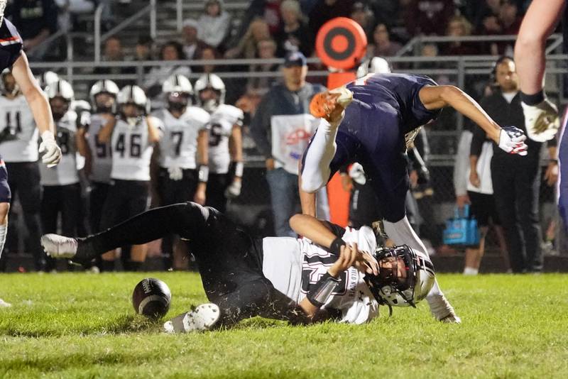 Oswego’s Jeremiah Cain (1) hits Plainfield North's Justus Byrd (13) in the backfield forcing a fumble during a football game at Oswego High School on Friday, Sept. 27, 2024.