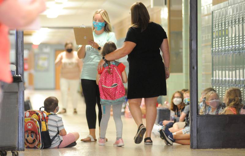 Grand Ridge Grade School staff direct students to their classrooms on the first day of school on Wednesday, Aug. 18, 2021.