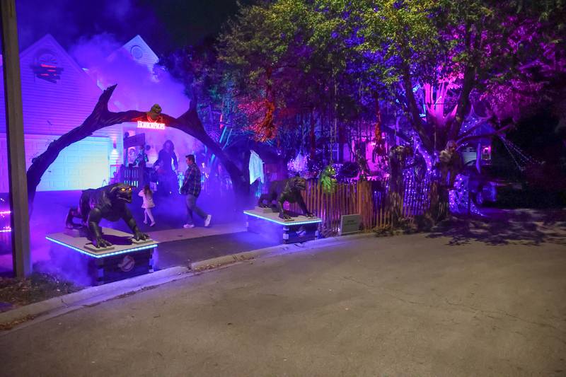 A father brings his daughter to see the newest Halloween display by Dave Appel HorrorProps, who made national attention with his “Stranger Things” display, on Thursday, Oct. 17, 2024 in Plainfield.