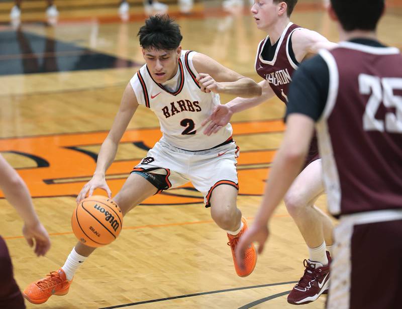 DeKalb's Aaron Ziga drives around Wheaton Academy's Josiah Nichols during their game Wednesday, Jan. 14, 2026, at DeKalb High School.