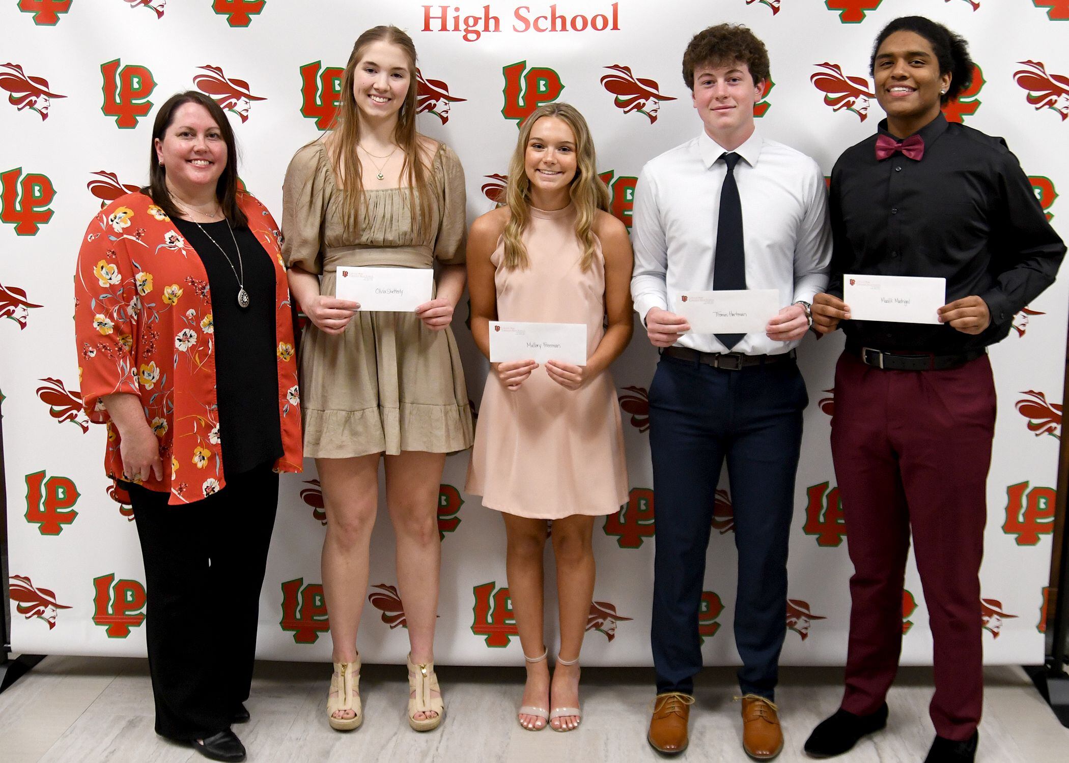 Olivia Shetterly (starting second from left), Mallory Freeman, Thomas Hartman, and Maalik Madrigal, all LaSalle-Peru Township High School seniors, received Athletic Booster Club Scholarships. The L-P Athletic  Booster Club presents these $500 scholarships to L-P student-athletes who participate in at least one sport each year of high school, have a GPA of at least 3.0, have at least one parent active in the Athletic Booster Club, and who complete an essay. The recipients also have their named added to a plaque. The scholarships were presented by L-P Booster Club president Tara Backes (left). Madrigal also received the Herbert W. Bekermeier Scholarship. The $1,000 scholarship is awarded to a graduating senior who has received a varsity letter for participation in track or basketball.
