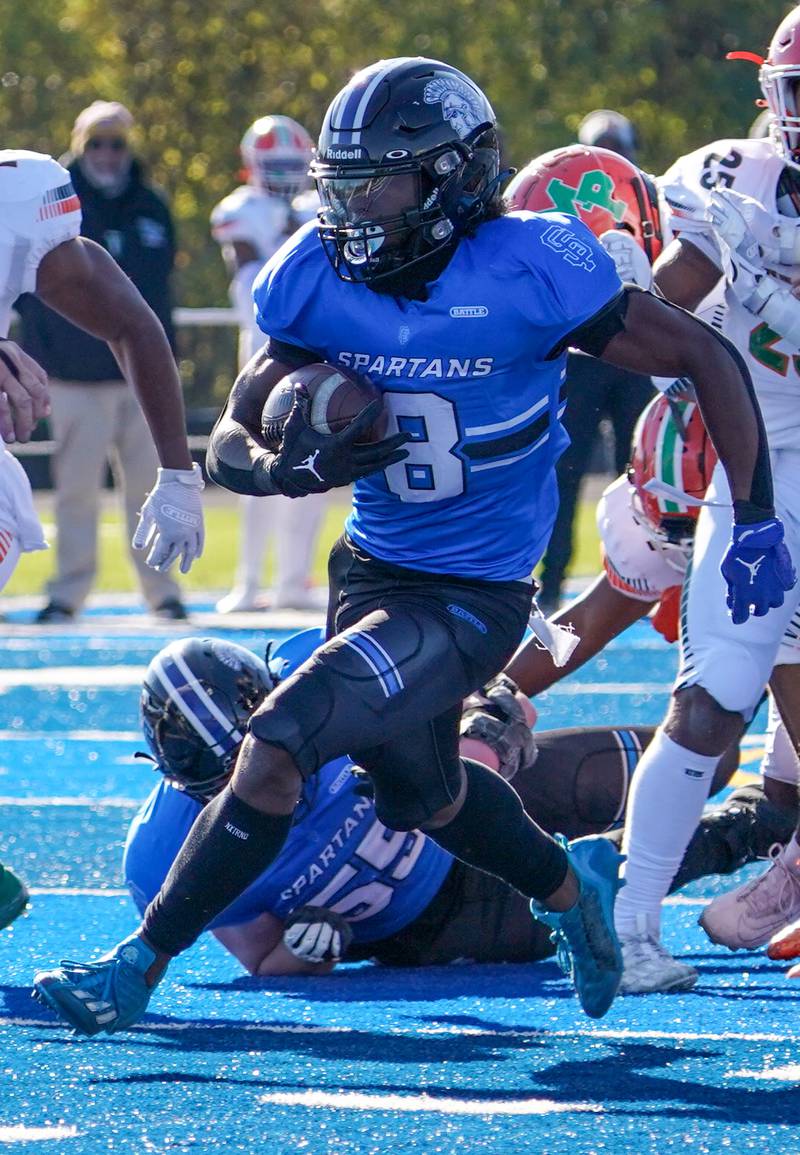 St. Francis' Tyvonn Ransom (8) carries the ball for a touchdown against Morgan Park during a class 5A state quarterfinal football game at St. Francis High School in Wheaton on Saturday, Nov 11, 2023.