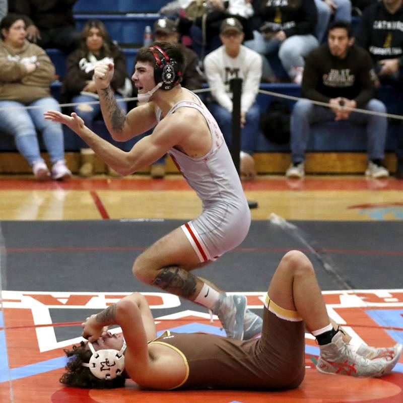 Marian Central's Vance Williams celebrates his pin of Mt. Carmel's Jairo Acuna in their 150-pound match during a triangle wrestling meet on Saturday Jan. 11, 2025, between Marian Central, Joliet Catholic, and Mt. Carmel at Marian Central High School in Woodstock.