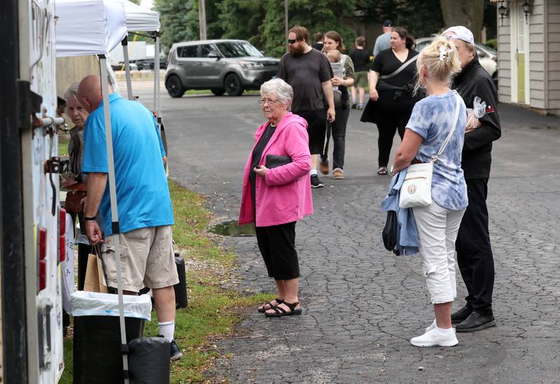 Attendees browse some of the booths Tuesday, June 3, 2025, during the the Sycamore Farmers Market, hosted by Kar-Fre Flowers and Gifts. The market will be held Tuesdays from 3-6 p.m. through August 26 at Kar-Fre Flowers. Some of the market was held indoors due to the weather.
