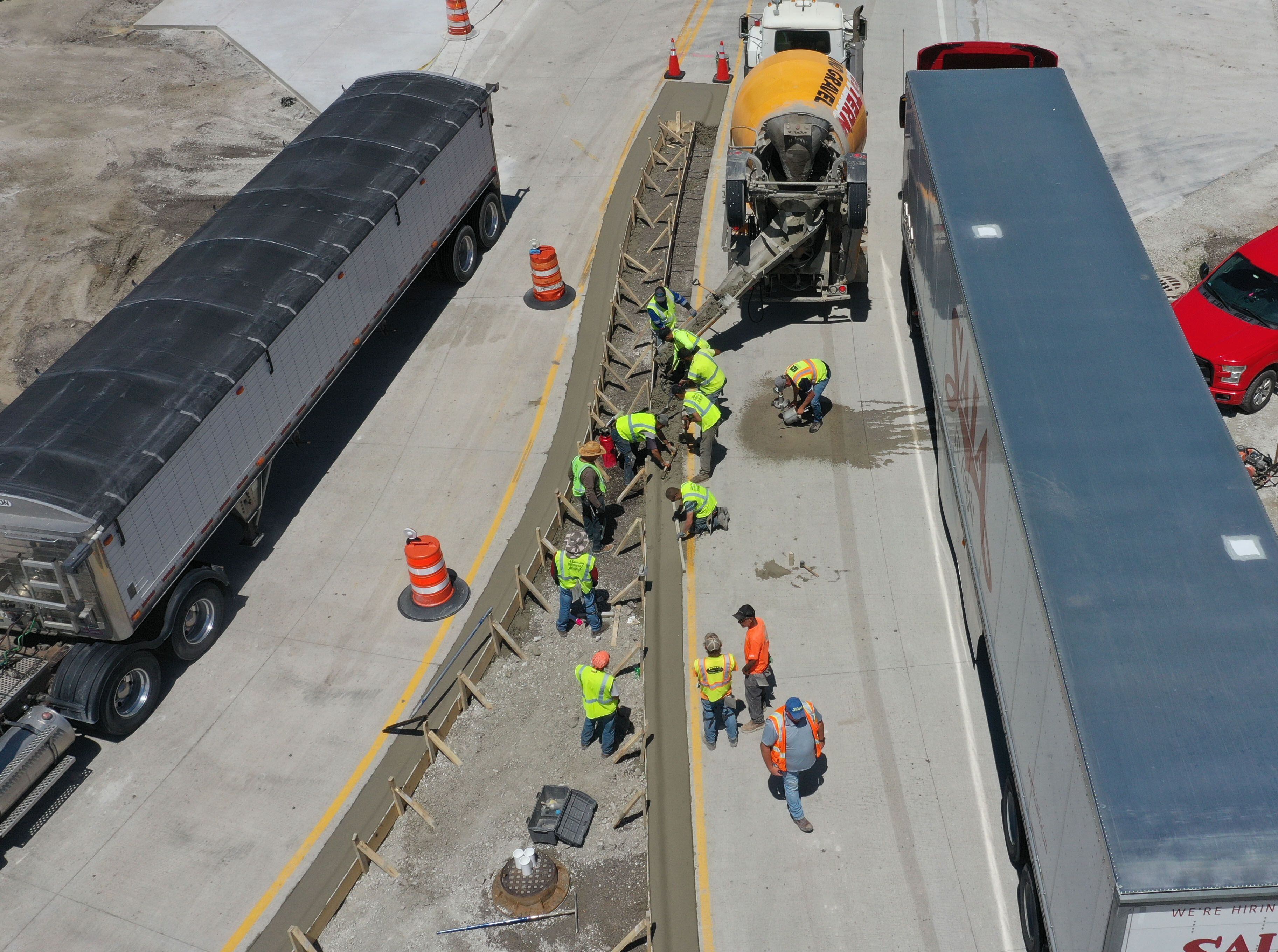 Crews pour concrete on the northern approach to the roundabout on Tuesday, May 16, 2023, at the intersection of Route 178 and U.S. 6 in Utica.