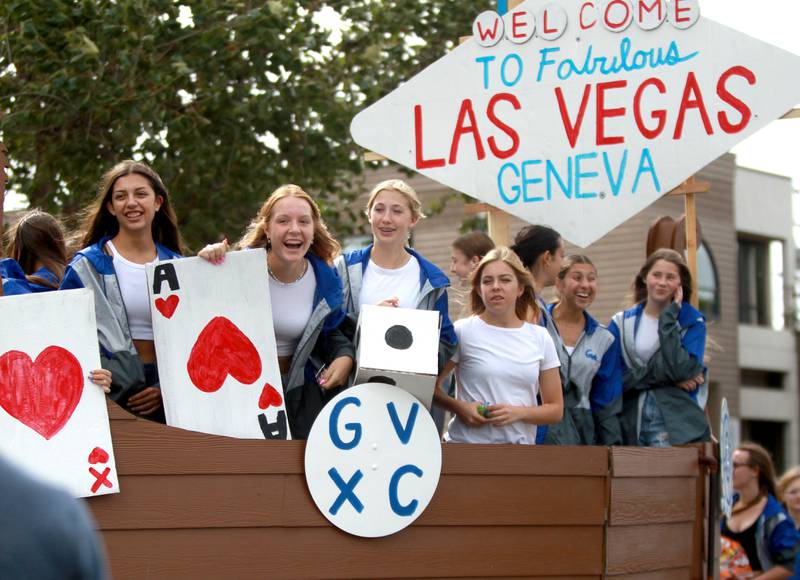 Geneva cross country runners ride on top of a float on Friday, Sept. 27, 2024 during the school’s annual homecoming parade.
