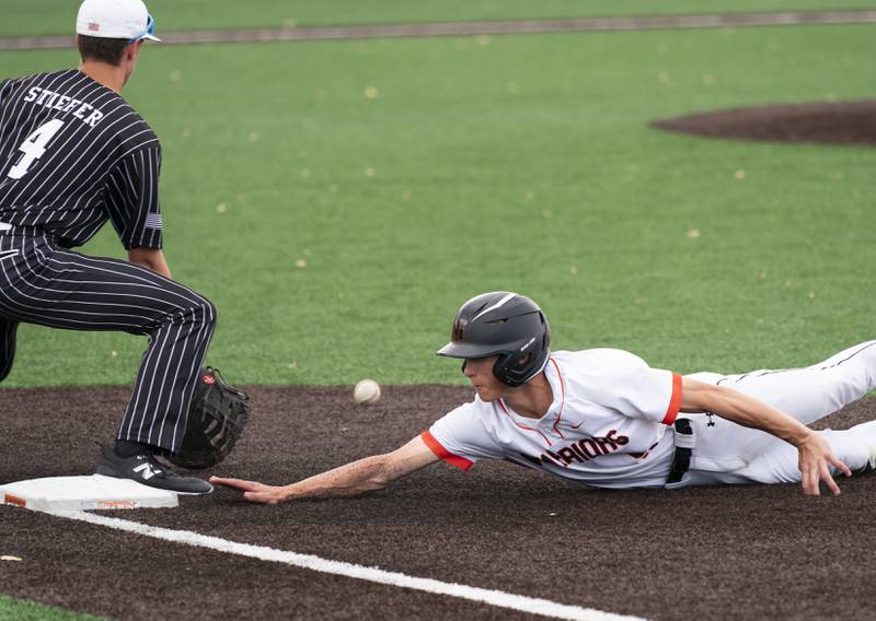 McHenry's Landon Clements dives back to first base safe as Prairie Ridge's Karson Stiefer tries to make the out during their game on Friday, May 16, 2025 at McHenry High School. Ryan Rayburn for Shaw Local