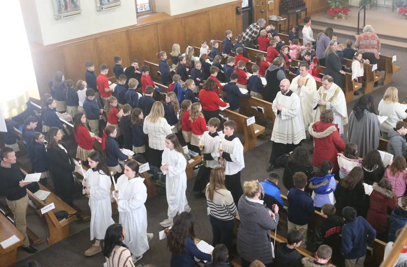 Students from Academy of St. Carlo Acutis, exit during the very first all-school Mass on Friday, Jan. 30, 2026 at St. Joseph’s Catholic Church in Peru.