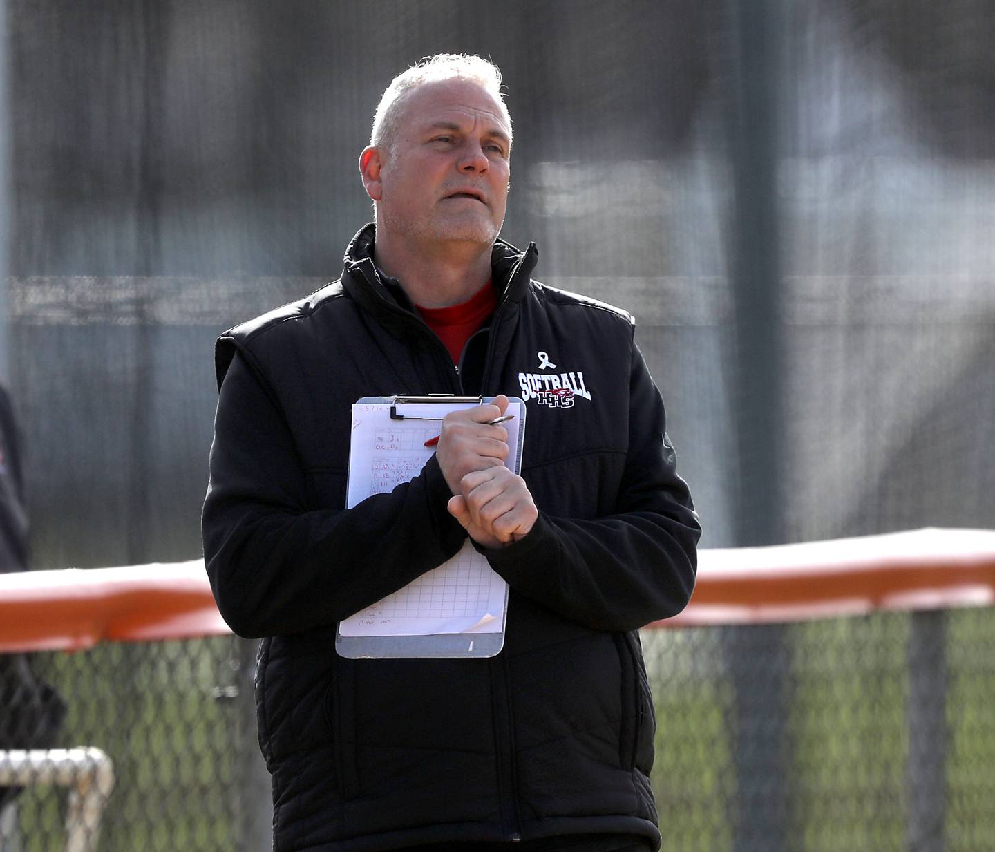 Huntley Head Coach Mark Petryniec pass on information to the bater during a Fox Valley Conference softball game against Crystal Lake Central on April 7, 2026, at Crystal Lake Central High School.