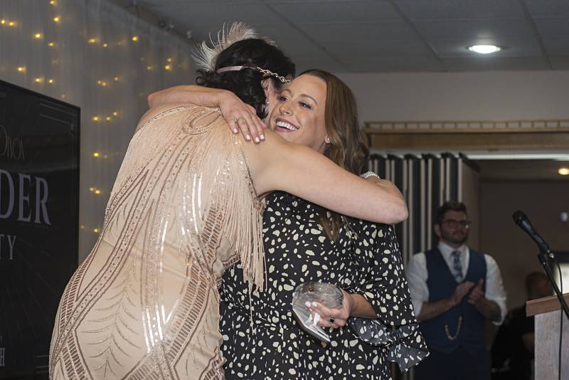 Lauren Mills (right) gets a hug after being named one of the 4 under 40 award winners Friday, May 6, 2022 at the Best of Dixon awards.