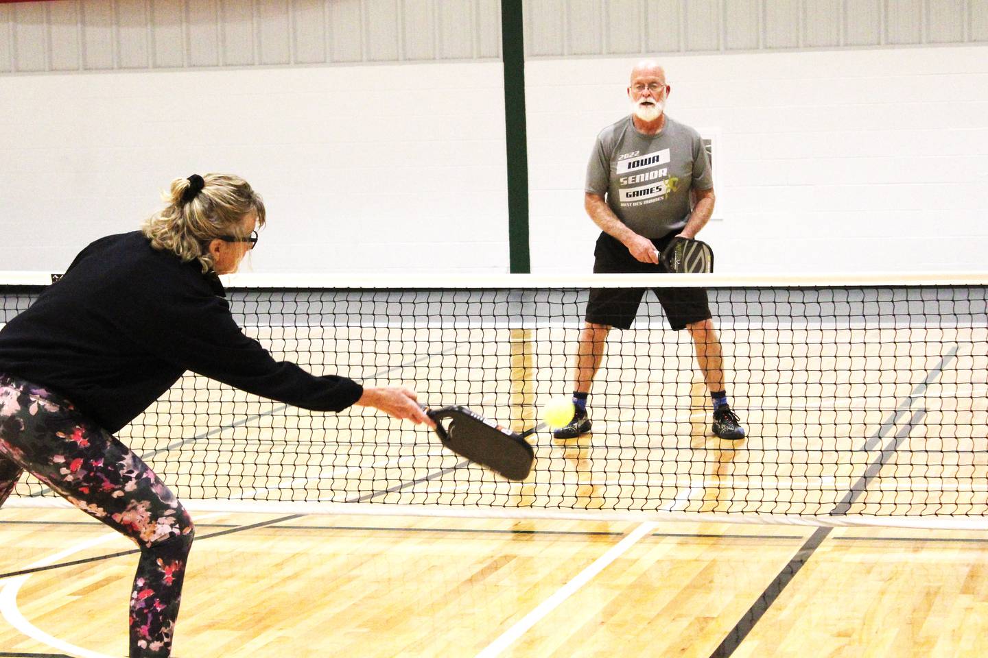 Cherie Lower of Lanark returns a volley to her husband Mark during a pickleball game Tuesday, Nov. 25 at the Davis Community Center in Mount Carroll.