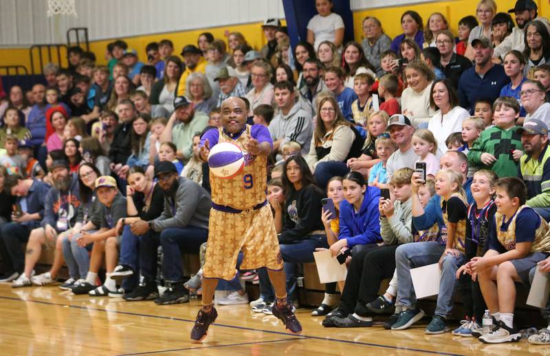 Harlem Wizards player Arnold Bernard (A-Train) sinks a half-court shot during the Harlem Wizards event on Tuesday, Oct. 28, 2025 in Pannebaker Gymnasium at Logan Jr. High School in Princeton.