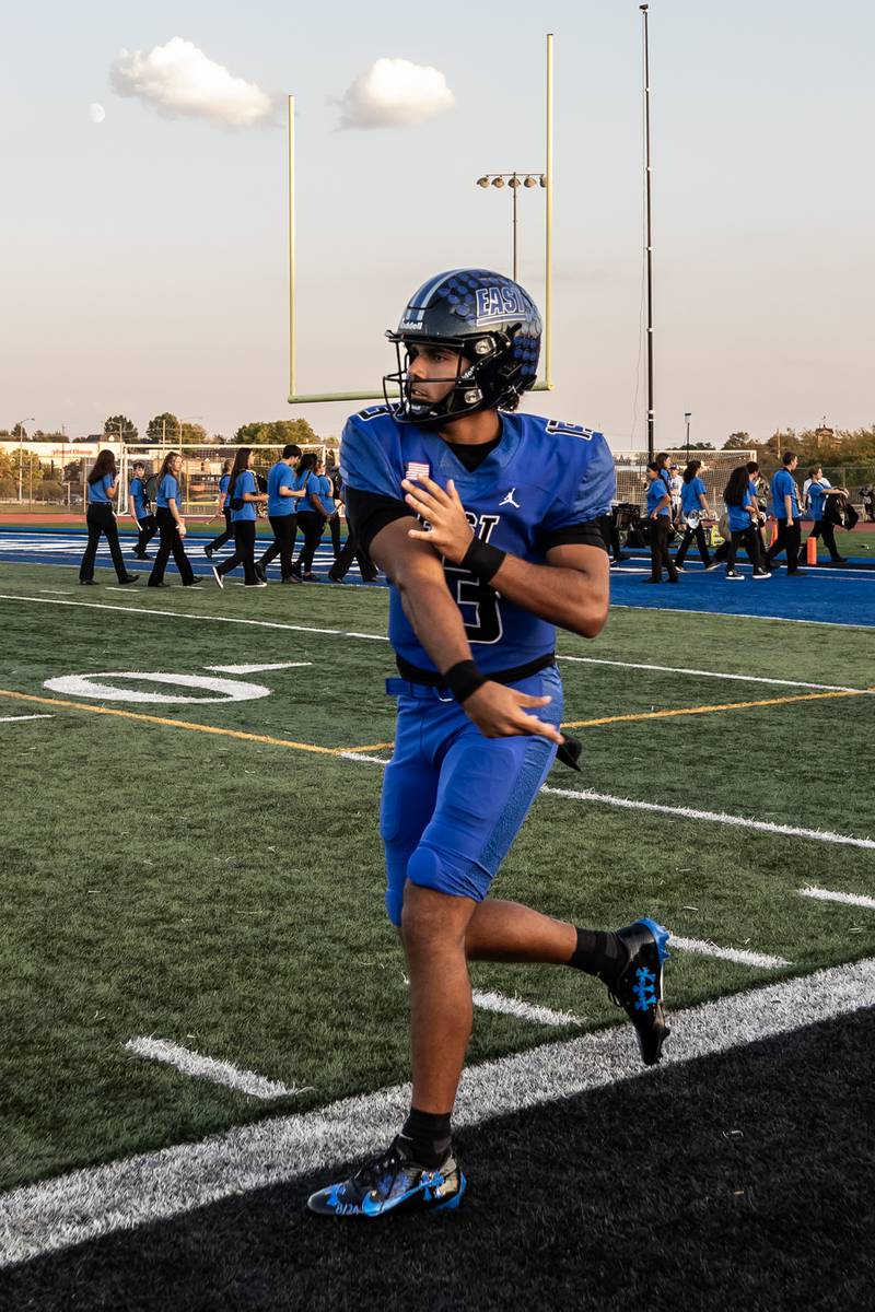 Lincoln-Way East's Jonas Williams warms up before the varsity football game against Metea Valley at Lincoln-Way East on Oct. 3, 2025. Williams went on to break the state passing touchdown record during the game.