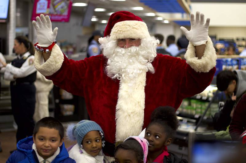 Joliet Police Officer Tony Lakota, dressed as Santa Claus, brings Christmas cheer to the children participating in the 36th annual Santa's Cops event on Saturday, Dec. 6, 2025, at Walmart, 401 Illinois Route 59, in  Shorewood.