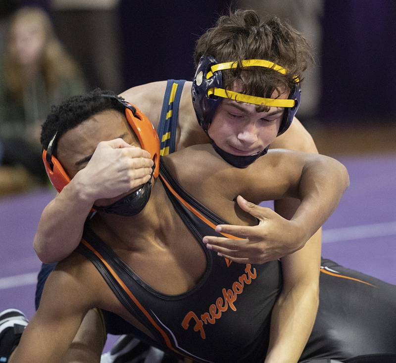 Sterling’s Landon Heckman grapples with Freeport’s Braylon Cain Tuesday, Jan. 13, 2025, in a triangular meet at Dixon High School.