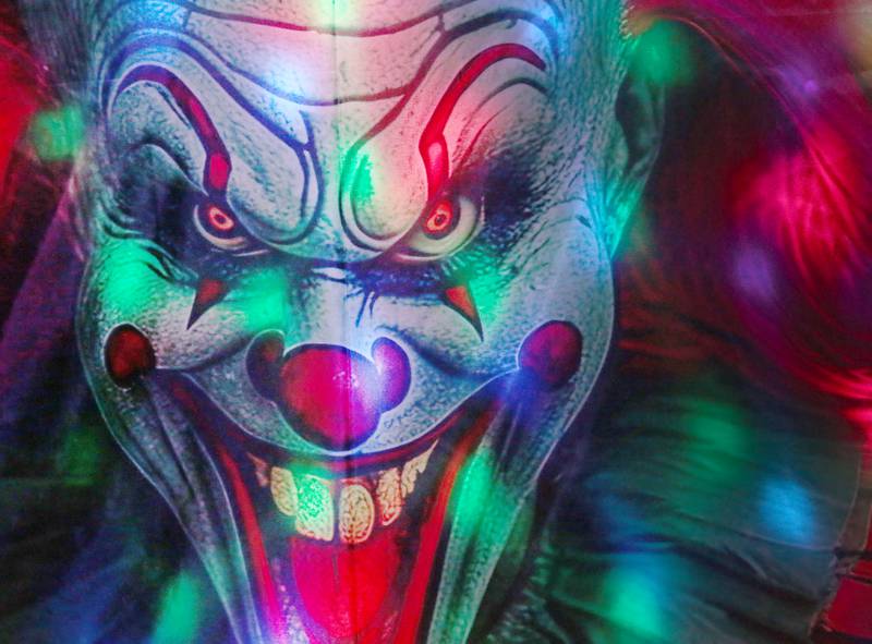 A creapy clown mural illuminates during the Nightmare on Fairgrounds Road Haunted Attraction on Wednesday, Sept. 25, 2024 at the Bureau County Fairgrounds in Princeton.