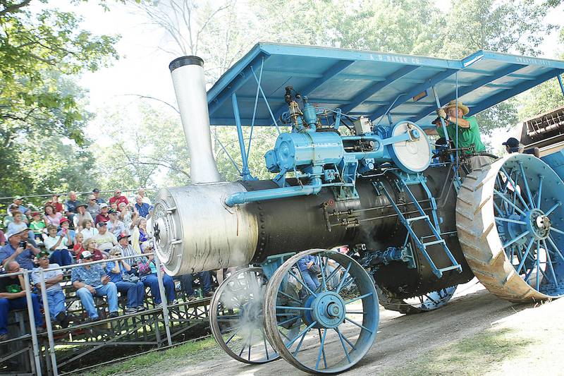 Les Petersen, 70, of Hampshire, drives his 1925 Baker 21-75 horsepower in the parade on Thursday, August 14, 2014, at the Northern Illinois Steam Power Club's Steam Show and Threshing Bee at Taylor Marshall Farm in Sycamore.  He said he's been to every Steam Show and Threshing Bee except in 1966 when he was in the army.