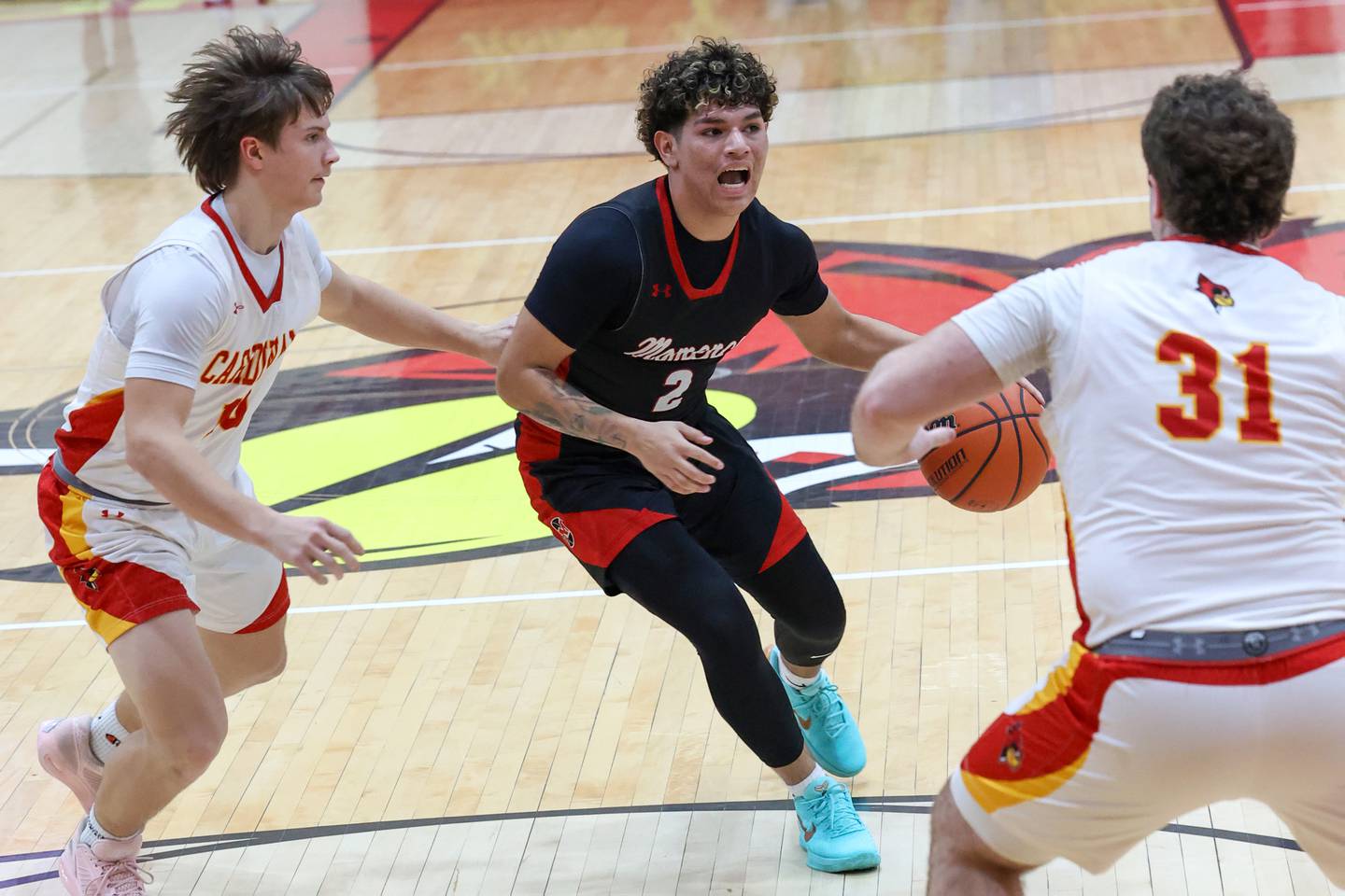 Momence's Erick Castillo drives to the lane against St. Anne defenders during St. Anne's 64-43 victory in the River Valley Conference semifinals on Tuesday, Feb. 10, 2026.