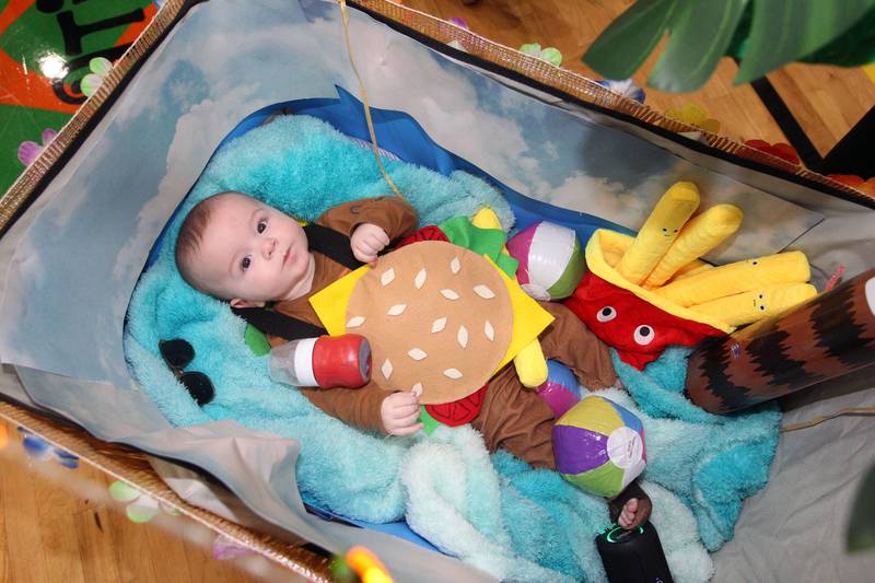 Canaan Rowland, five-months-old, of Lindenhurst wears a "Cheeseburger in Paradise" costume during Witchy Thrills & Chills at the Lindenhurst Park District Lippert Community Center on October 14th in Lindenhurst. Canaan's family was also with him, all dressed with a tropical theme.
Photo by Candace H. Johnson for Shaw Local News Network