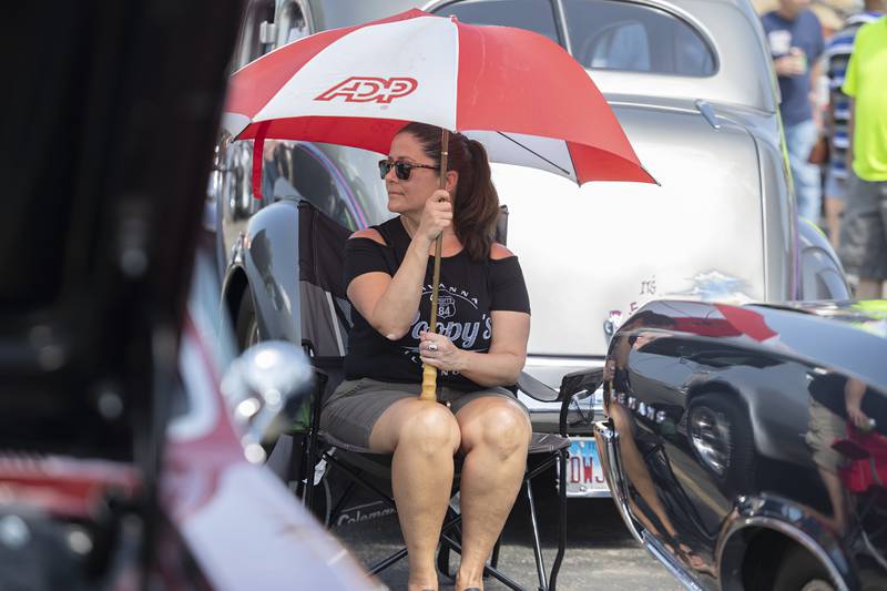 Paulette Hill of Princeton shades herself while attending the Amboy Depot Days’ car show Sunday, August 27, 2023. Hill was there with her boyfriend who had on display his ’66 Pontiac LeMans.