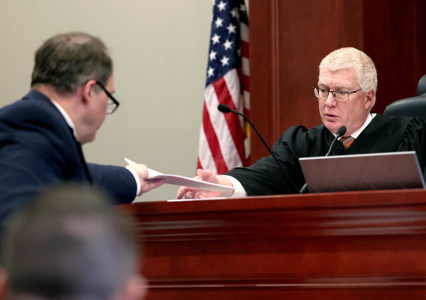 Lead prosecutor Daniel Regna presents some papers to Circuit Court Judge Philip Montgomery during a pretrial hearing of Matthew L. Martin, charged with armed robbery, on Thursday, April 3, 2025, at the DeKalb County Courthouse in Sycamore. Martin in charged in connection to a DeKalb bank robbery in July 2024.