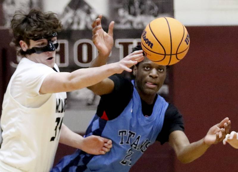 Prairie Ridge's Tiago Gray tries to gain control of a loose ball in front of Illinois Math & Science Academy's Omar Njikam during a IHSA Class 3A Burlington Central Regional quarterfinal boys basketball game on Monday, feb23, 20256, at Prairie Ridge High School in Crystal Lake.
