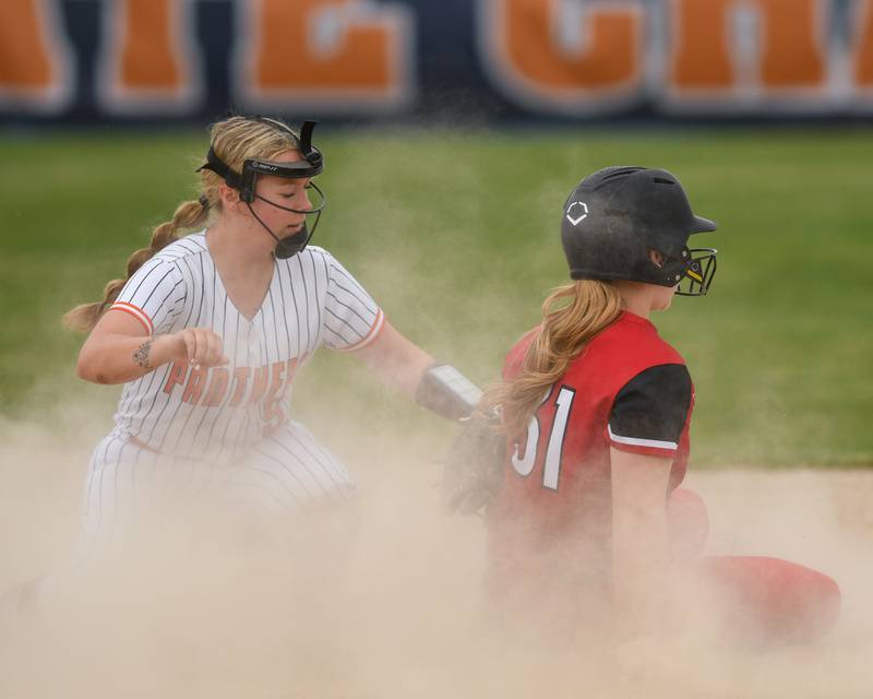 Oswego's Kennedy Gengler, left,  tries to tag out Benet Academy's Avery Burns (31) during the regional final game on Friday May 22, 2026, held at Oswego High School.
