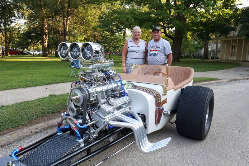 Neil and Ronna Hambly, of Yorkville, stand with Neil's custom-built, front engine dragster, featuring the theme Yosemite Sam, during the Cruise-In Night at the Museum on Thursday, Aug. 14, 2025. Inspired by 70's drag racing and his childhood love for the cartoon characger, Neil and Ronna began bringing the 2-seater car to shows upon its completion about two and a half years ago.