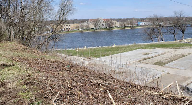 The view of Dixon High School, the Rock River and a reclaimed brownfield can be seen where brush has been removed in recent weeks atop the former Illinois Central Railroad line in Dixon on Tuesday, April 11, 2023. Dixon was awarded a $2.25 million state grant for a bike path extension through the Illinois Transporation Enhancement Program.