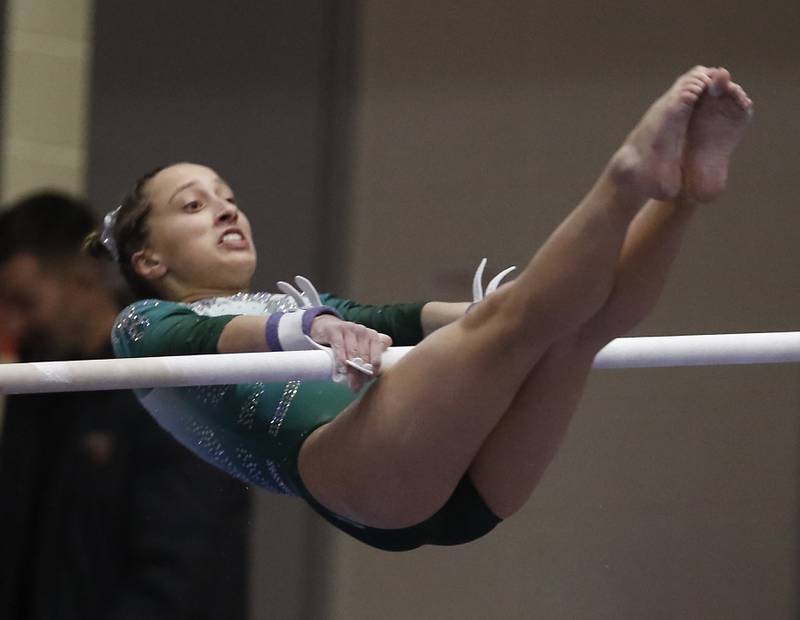 Glenbard West's Samantha Hopper competes in the preliminary round of theuneven parallel bars Friday, Feb. 17, 2023, during the IHSA Girls State Final Gymnastics Meet at Palatine High School.