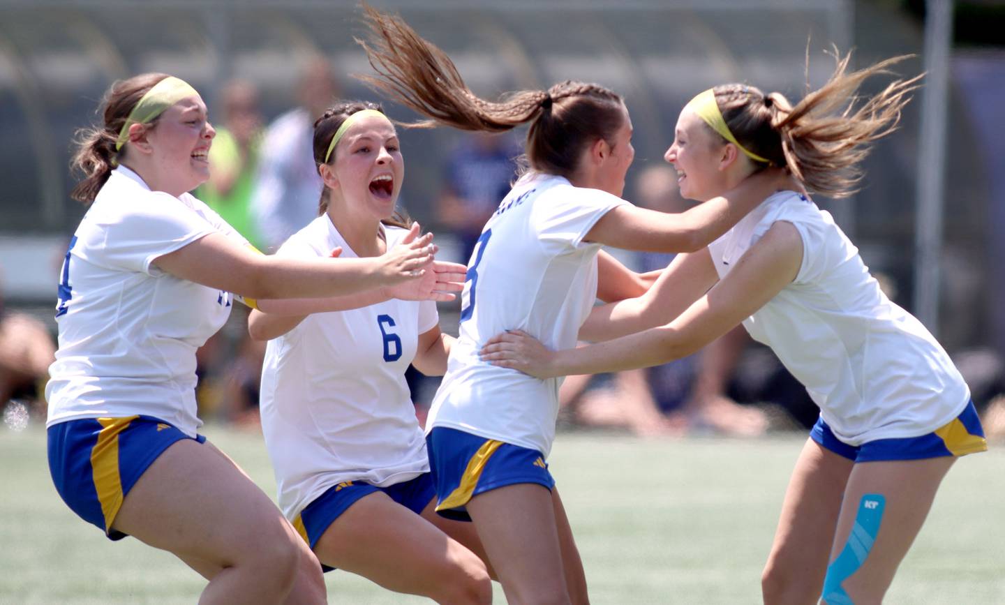Johnsburg’s Skyhawks celebrate after a Charlie Eastland penalty kick clinched a win over Willows Academy in IHSA Class 1A Supersectional soccer action at Dominican University in River Forest on Saturday, May 31, 2025. From left are Kayla Hiller, Liz Smith, Eastland and Devynn Michel