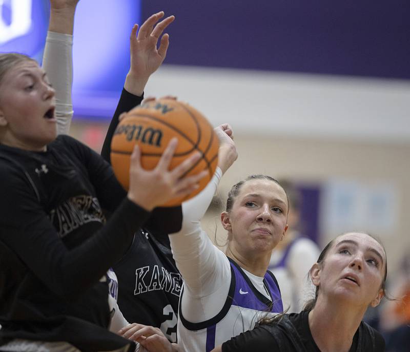 Dixon’s Presley Lappin looks to put up a shot against Kaneland’s Daniela Ridolfi (left) and Lillyana Crawford Wednesday, Dec. 10, 2025.