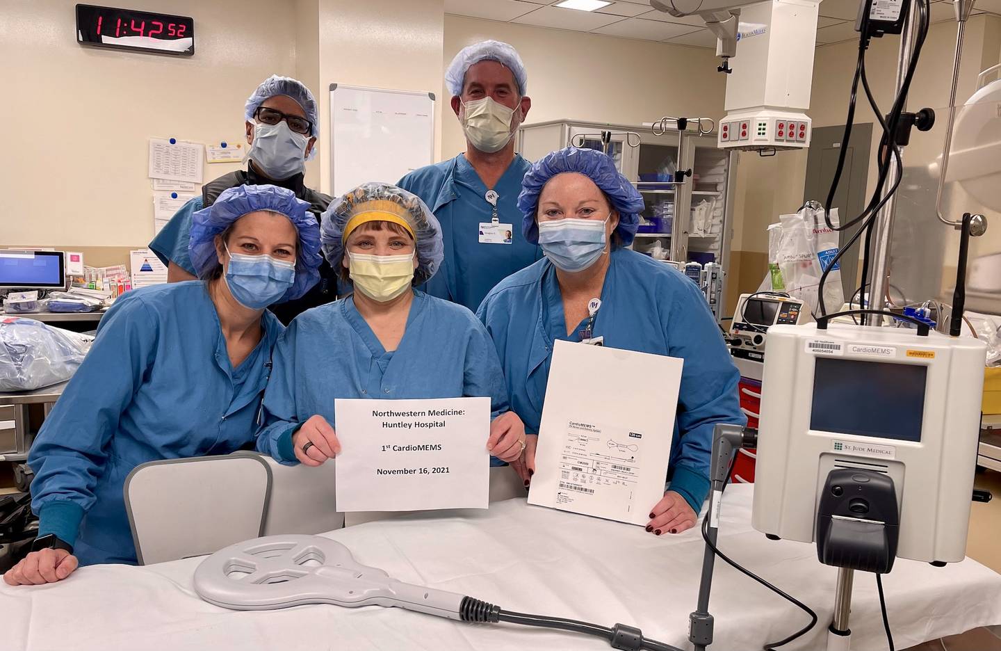 Medical staff at Northwestern Medicine Huntley Hospital take a picture following a heart procedure at the hospital. Medicine