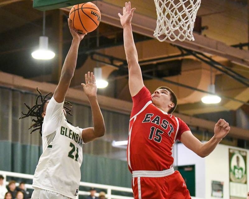 Glenbard West's AJ Rayford (21) takes a shot and gets fouled by Glenbard East Jacob Marynowski (15) on Wednesday Nov. 26, 2025, during the District 87 Thanksgiving Invitational held at Glenbard West High School.