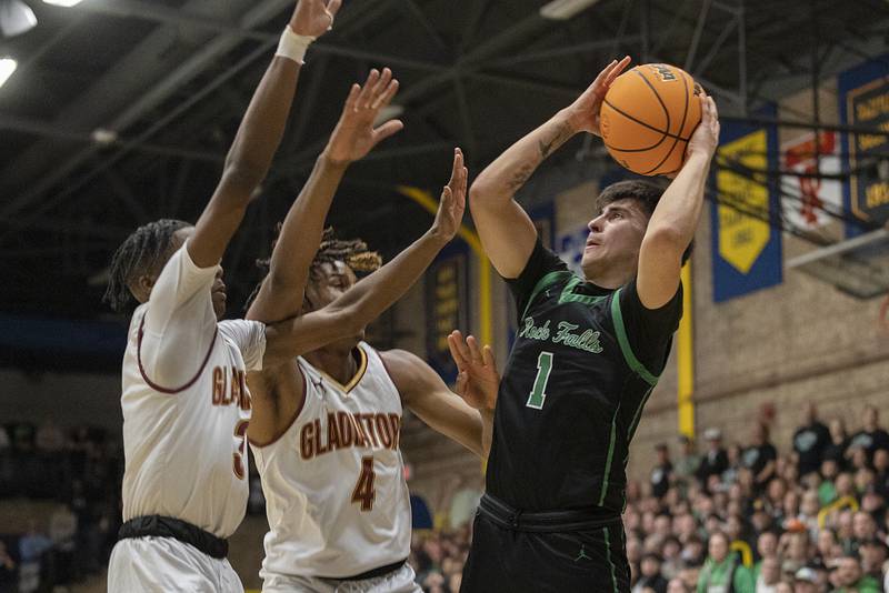 Rock Falls’ Austin Castaneda puts up a shot against Christ the King’s Mike Thomas and Malachi Johnson Monday, March 10, 2025, during the Class 2A boys basketball Supersectional in Sterling.