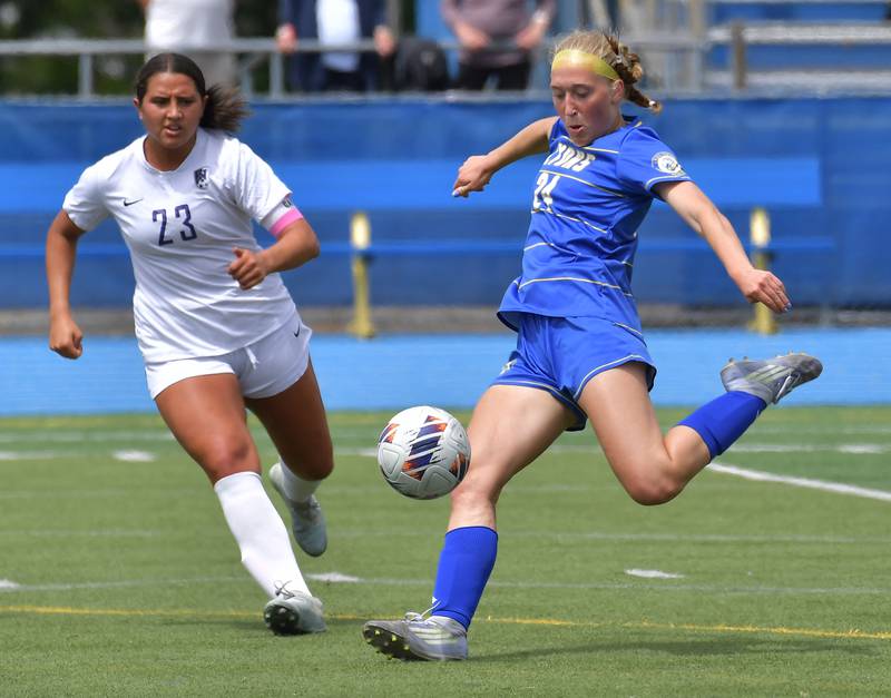Lyons Township’s Avery Lusk kicks the ball as Downers Grove North’s Gianna Goodwin (23) defends during their Class 3A Lyons Regional final on May 23, 2026 at Lyons Township High School in LaGrange.